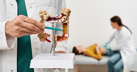 colon-model-with-pathology-in-doctor-hands-colonoscopy-concept